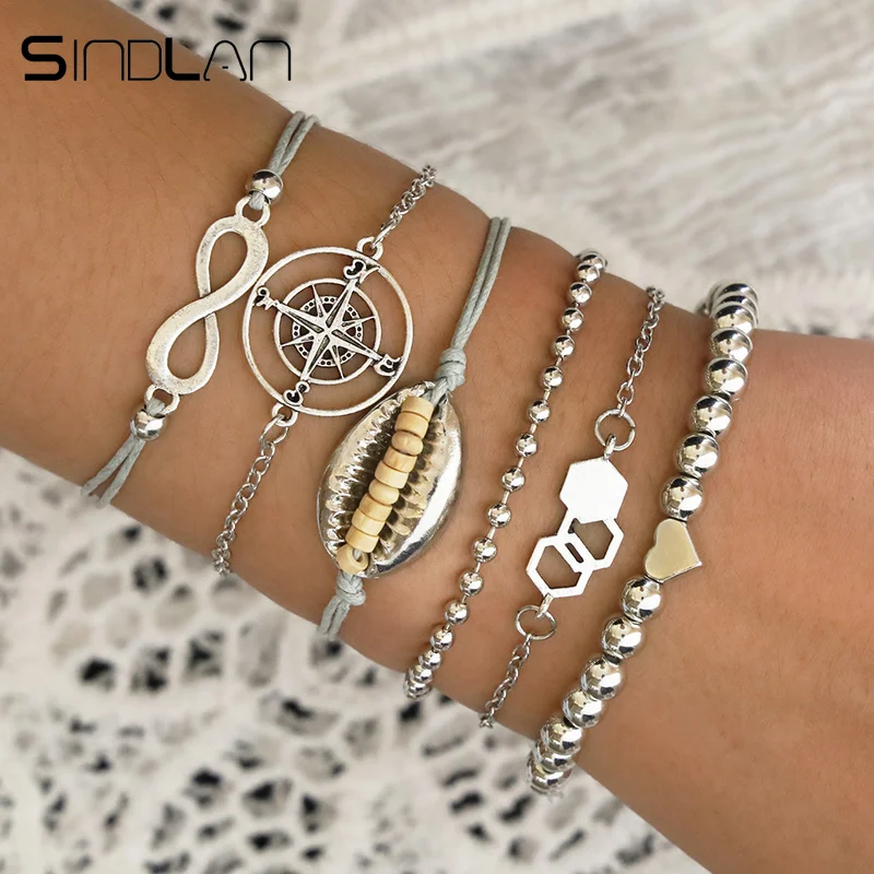 

Sindlan 6PCs Set Silver Beads Infinity Shell Bracelets for Women Hollow Compass Geometric Charm Boho Bracelets Set Wrist Jewelry