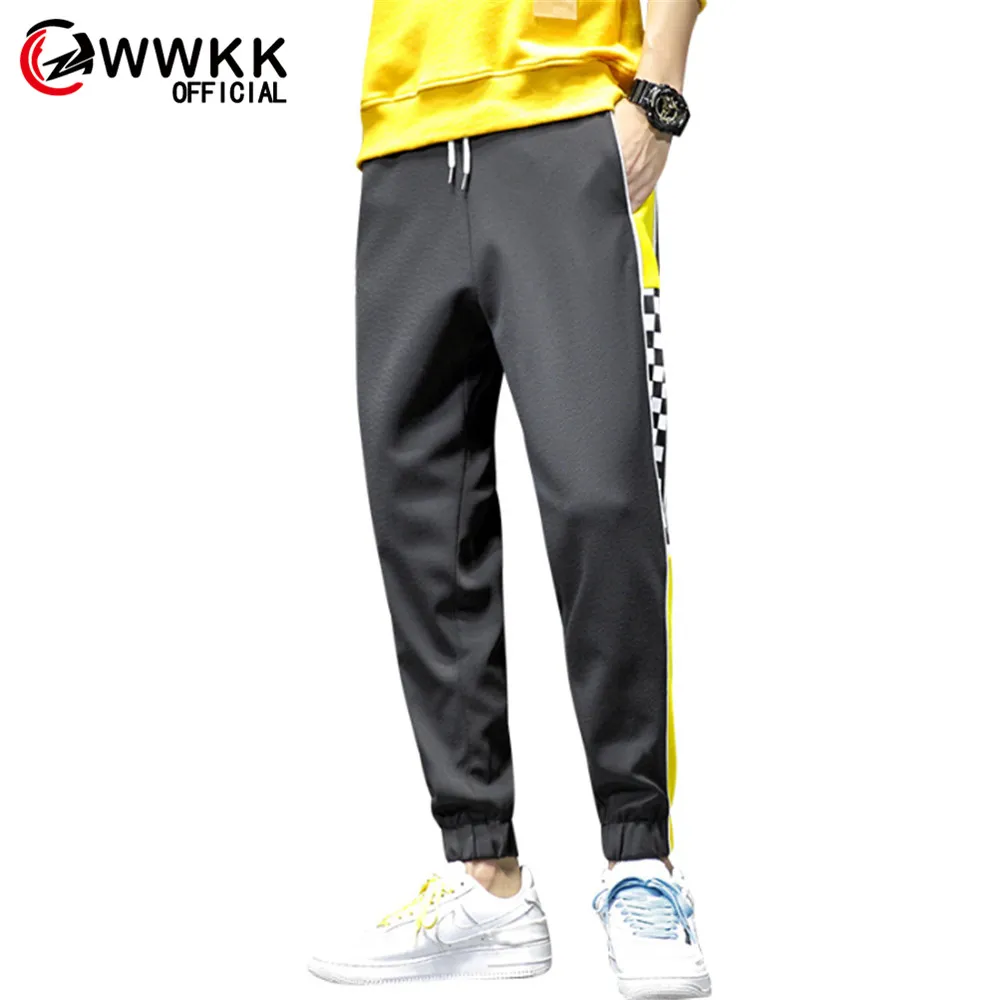 yellow track pants with black stripe