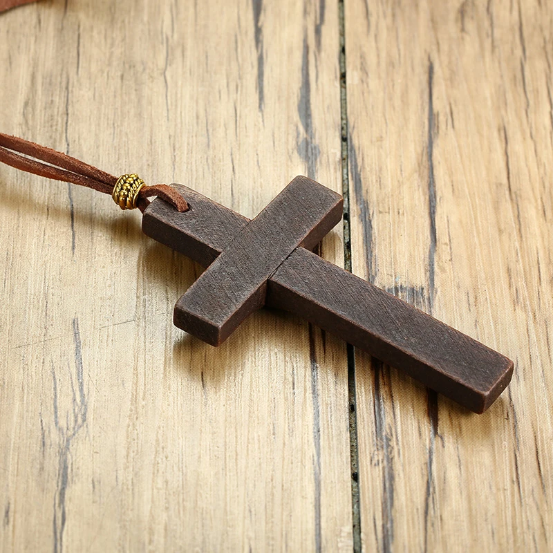 Wooden cross on brown faux suede cord.