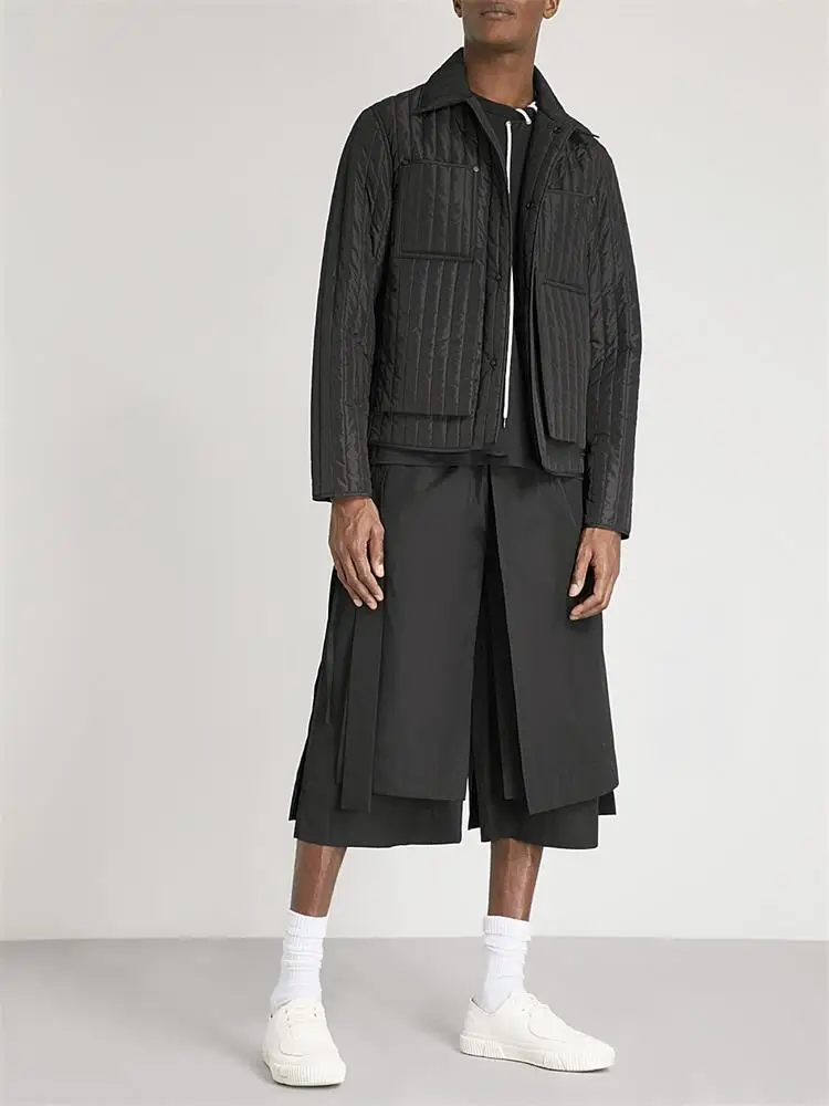 The new men\'s cropped trousers are dark and large size loose trousers with irregular asymmetrical wide legs