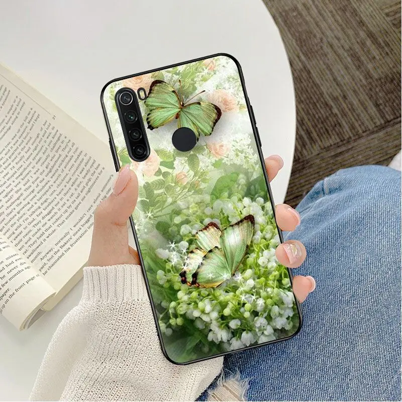 Red butterfly on white roses flower