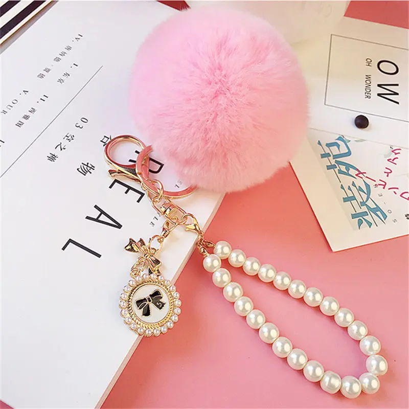 cheap Cute pompon keychains women Bunny fur ball pearl chain bow tag bag key chain car keyring porte clef holder fluffy pom pom gifts