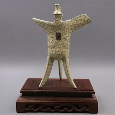

Imitation Ge kiln open piece three legged high foot Jue cup iron tire porcelain ornament