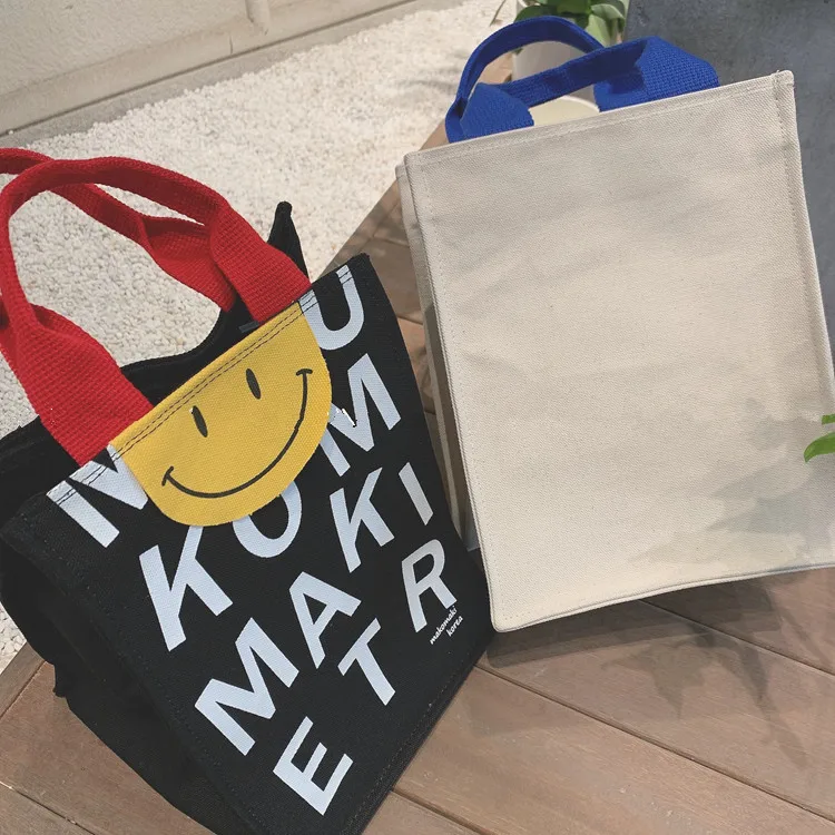 2022 Canvas bag New Summer Korean Japanese Cartoon Canvas Smile Handbag Large Capacity Shoulder Bag Hit Color Letter Female Tote