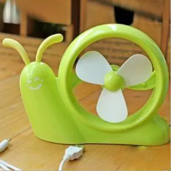 

Mini snail with yellow fan lying on the ground household daily products family familiar article of everyday use