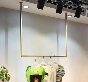 

Gold hanger on the wall of the display shelf of clothing store