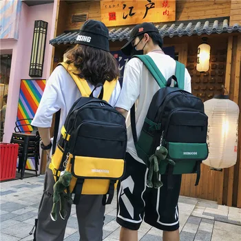 

New color contrast backpack men with pendant tide couple backpack large capacity travel bag ins super fire bag female