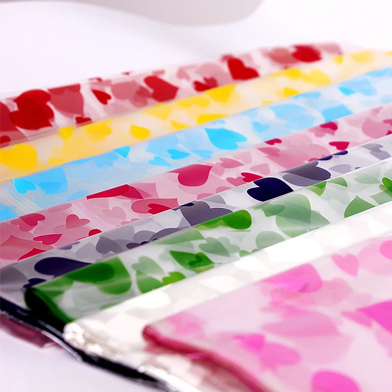 

Large Plastic Gift Packaging Cellophane Wrapping Paper for Christmas Packing Bag Doll Flowers Fruit Candy Christmas Party Favors