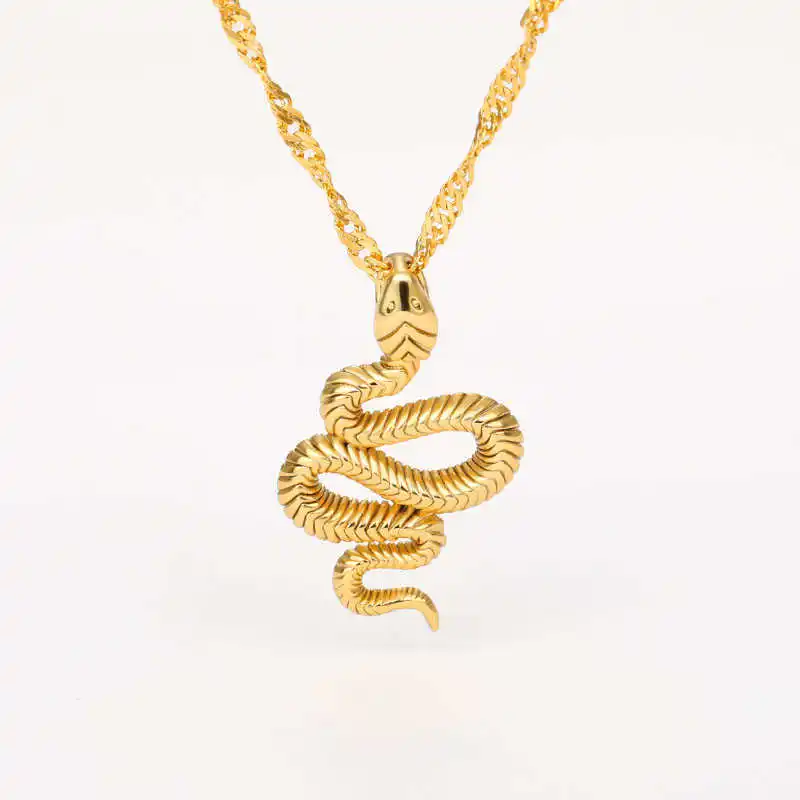 The Snake Pendant, showcasing a detailed snake design, dangles elegantly from a twisted gold chain against a plain white background. This chic jewelry piece is perfect for elevating your collection of women's fashion accessories.