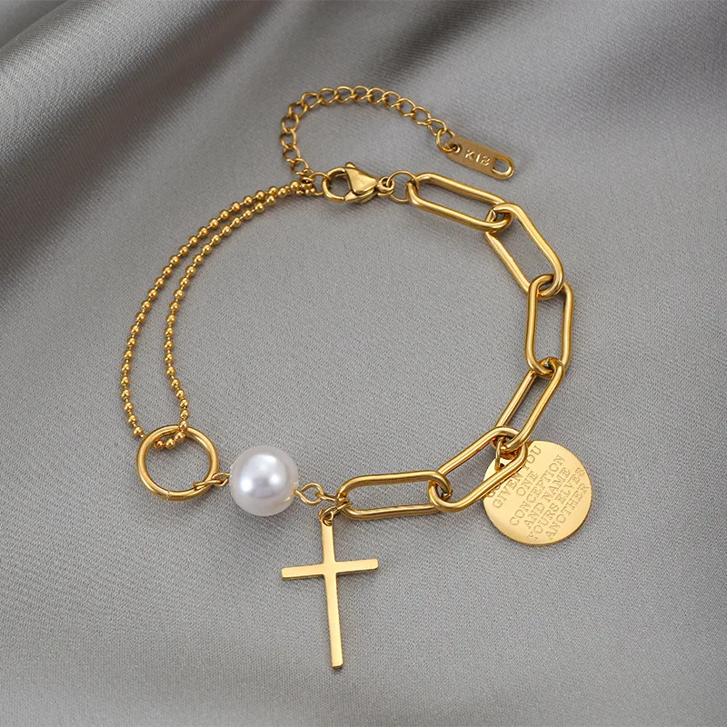 A Layered Golden Pendant Womens Bracelet - Coin Cross Pearl embellished with a cross and featuring a single pearl.