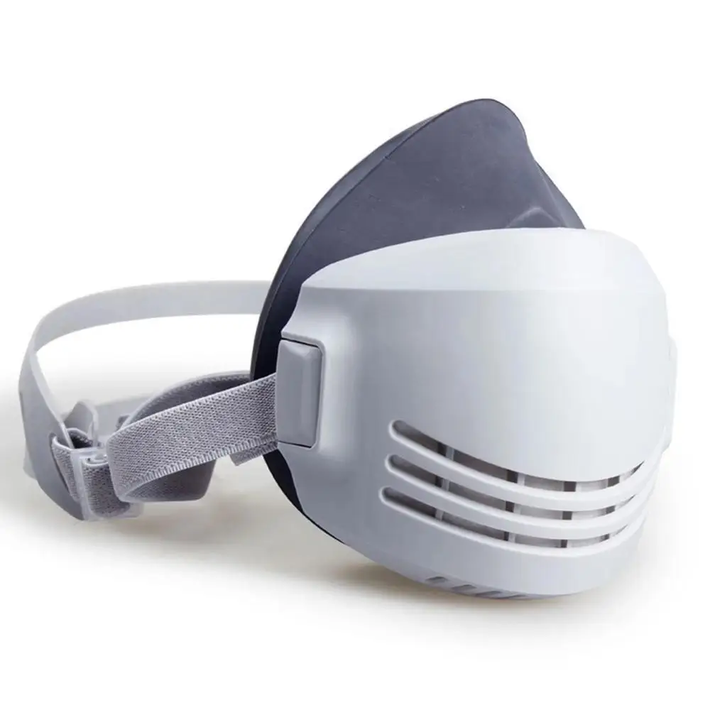 Masque anti-poussière PM2.5 réutilisable ouvert montrant l'emplacement du filtre, avec un filtre neuf à côté.