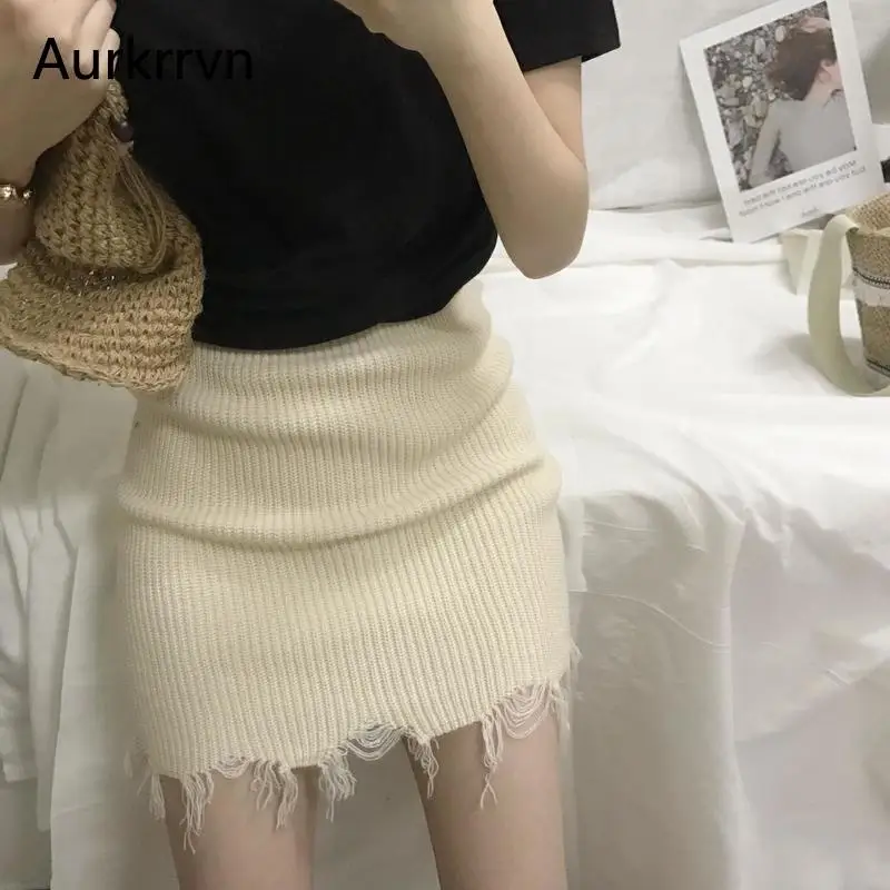 

Aurkrrvn Sexy Ripped Knitted Skirts for Women White Hole Wrap Short Skirt Female Street Party Elastic Club Skirts Femme 2020
