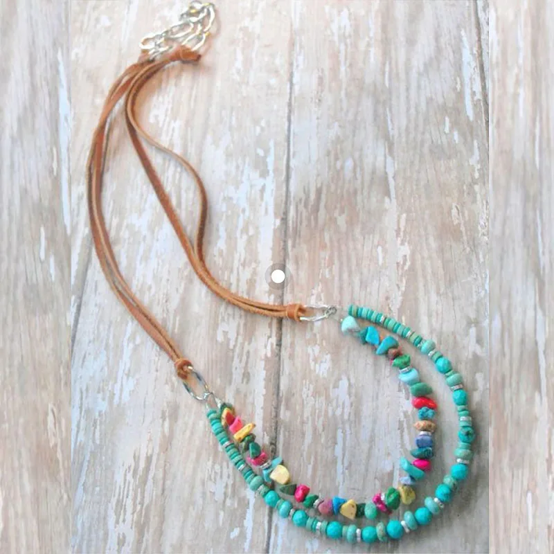 

Boho style dangle necklace - a metal feather, turquoise color dyed wagnerite chips and metal beads with fine cable chain