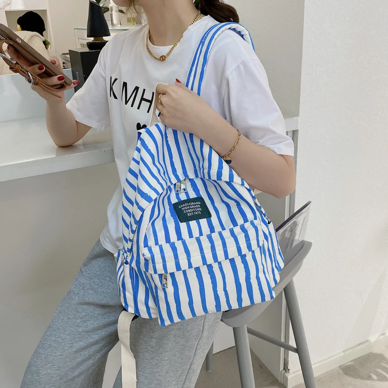 cool backpacks accessories	 Stripe Print Casual Lady Canvas Backpack New Listing Large Capacity Simple Student Backpack Fashion Wild Travel Hand Bag most stylish backpacks