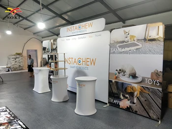 

10ft straight tension fabric backwall and a TV shelf banner with a promotion table and a roll up banner