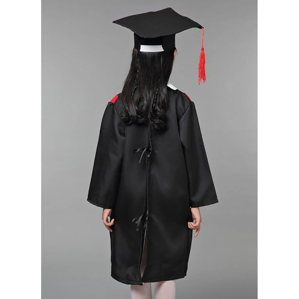 Elementary Age Boy And Girl Wearing Graduation Caps And Gowns Smile While  Standing With Degree In Hand Stock Photo - Download Image Now - iStock