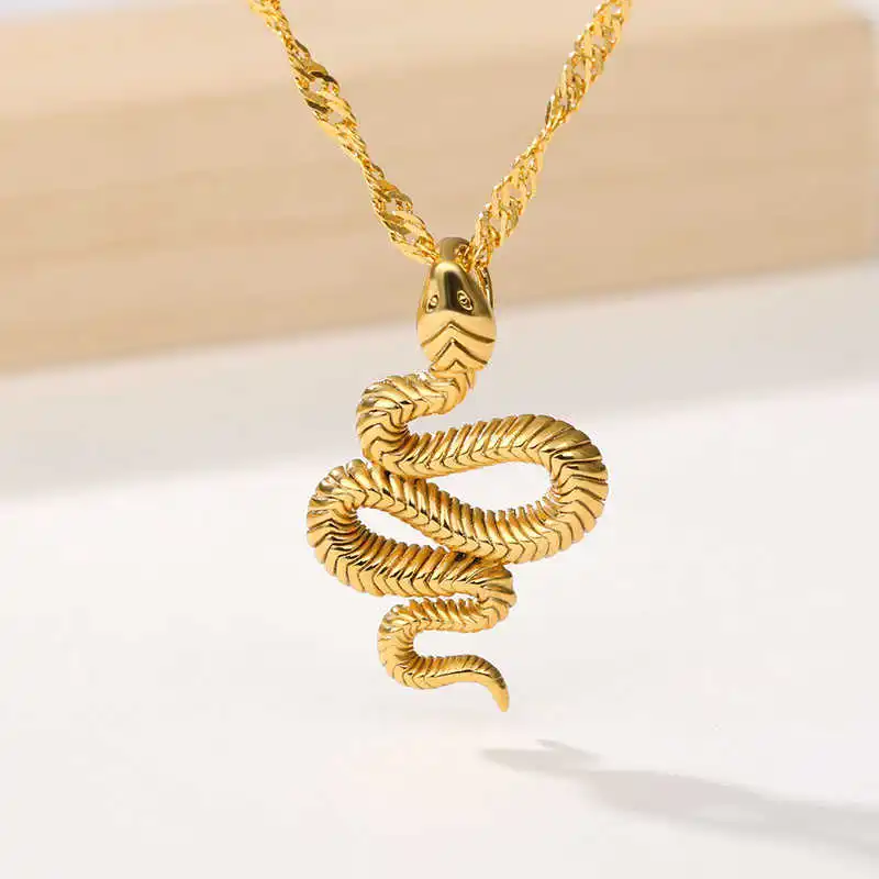 Close-up of the stylish Snake Pendant, showcasing its detailed design suspended on a twisted gold chain, set against a neutral background. This piece epitomizes chic fashion accessories.