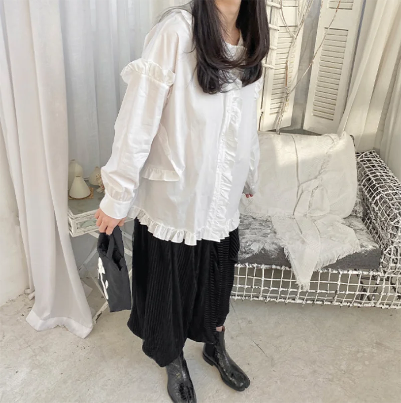 The new spring and autumn ladies loose flounces lapel long sleeve pure color blouse deconstruction art French blouse