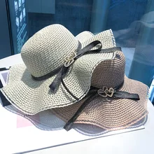 

European and American ladies wind fashion love bow curling dome big eaves ladies beach vacation spring / summer shade straw hat