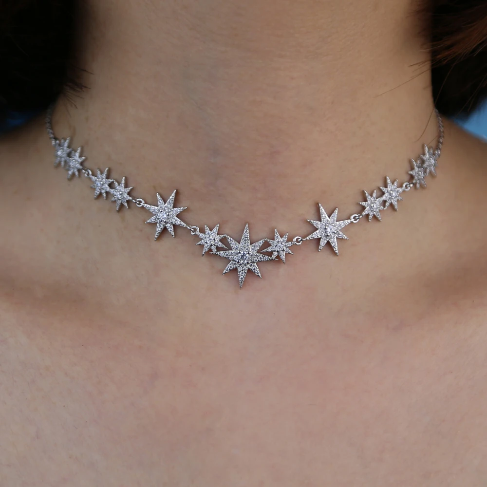 Model wearing a CZ starburst charm choker necklace with silver finish