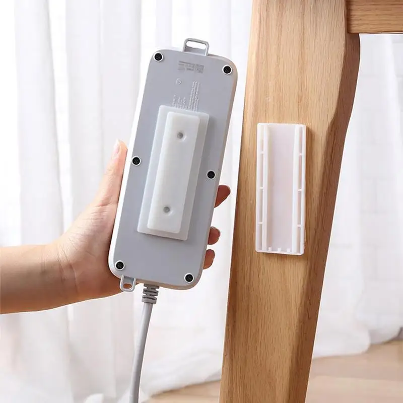 Tira de enchufe autoadhesiva, retenedor de enchufe de fila sin perforaciones, Panel de parche de pared, organizador de Cable de montaje en pared