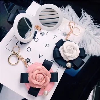 

Fashion Leather Camellia Bow Pearl Key Chain Carry Makeup Small Mirror Bag Pendant Women Car Key Chain Bag Accessories