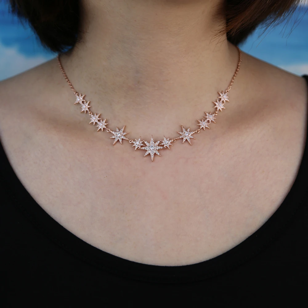 Model wearing a CZ starburst charm choker necklace with silver finish