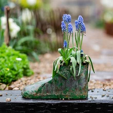 

decorative rustic green metal boot planter