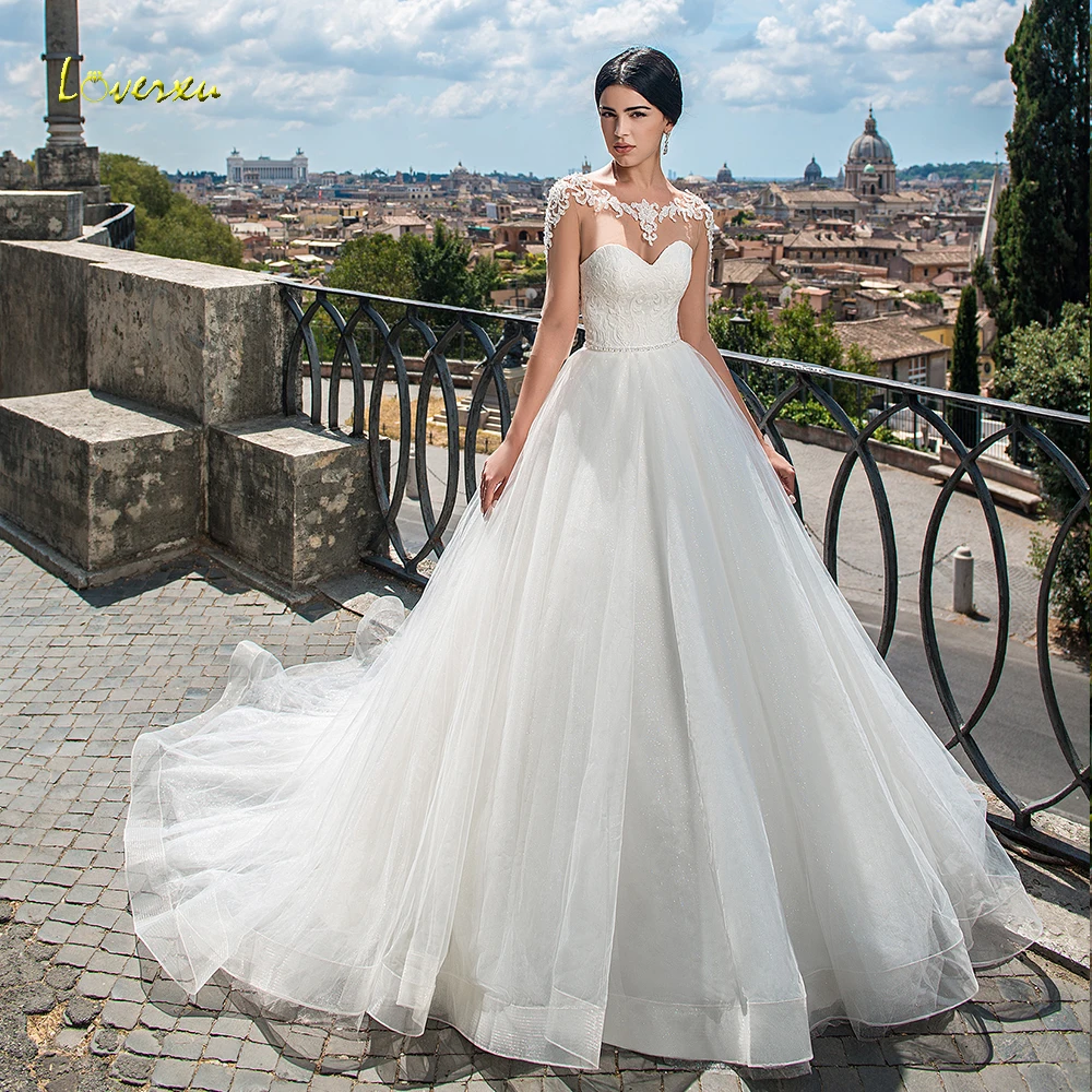 

Loverxu Scoop A Line Glitter Wedding Dresses Demure Applique Cap Sleeve Backless Bride Dresses Court Train Bridal Gown Plus Size