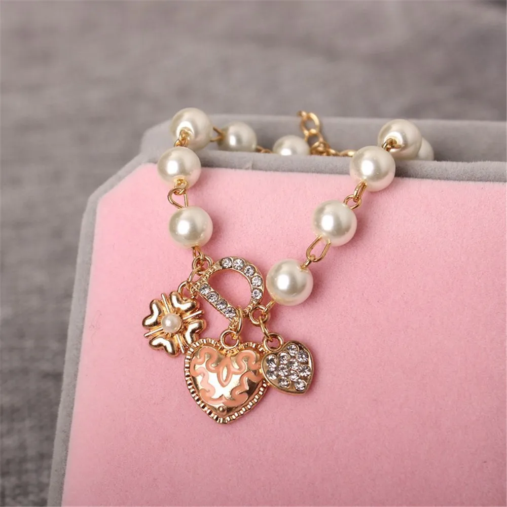 Женский браслет с кристаллами золотого цвета искусственным жемчугом и надписью D