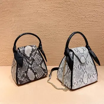 

New high quality leather fashion trend personalized rabbit ear snake cross bucket bag one shoulder women's handbag