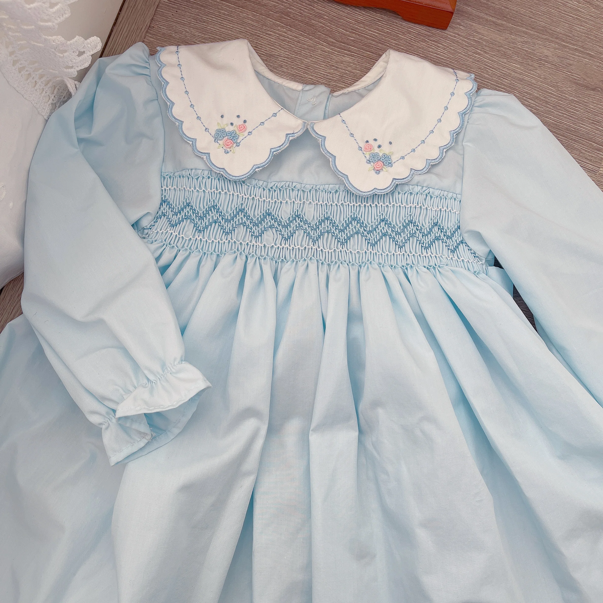 Petit Bebe Knits Girls Blue Smocked Long Sleeve Dress with White Collar main image 0