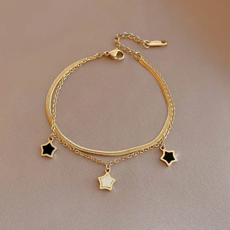 A Layered Golden Pendant Womens Bracelet - Coin Cross Pearl with black and white charms.