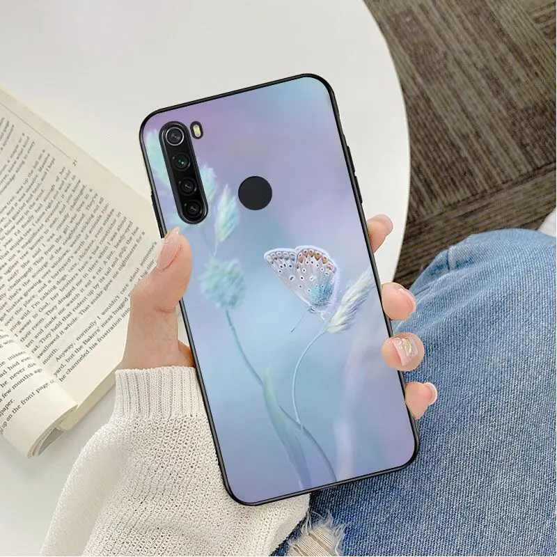 Red butterfly on white roses flower