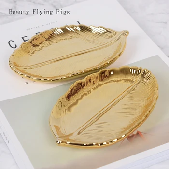 

Direct sales new listing modern golden leaf ceramic storage tray leaf jewelry plate dried fruit dish home decoration ornaments