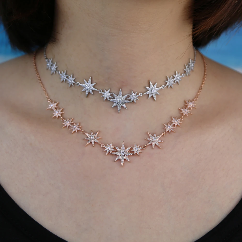 Model wearing a CZ starburst charm choker necklace with silver finish