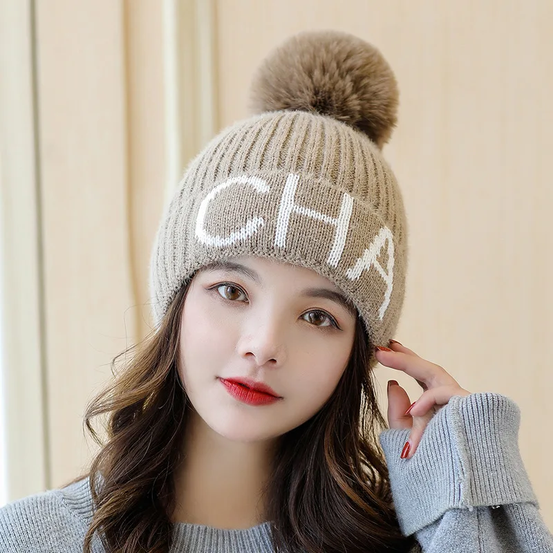 

New autumn and winter wool ball knitting wool hat letter fashion warm and thick cold proof Pullover Hat Women's Skulls & Beans