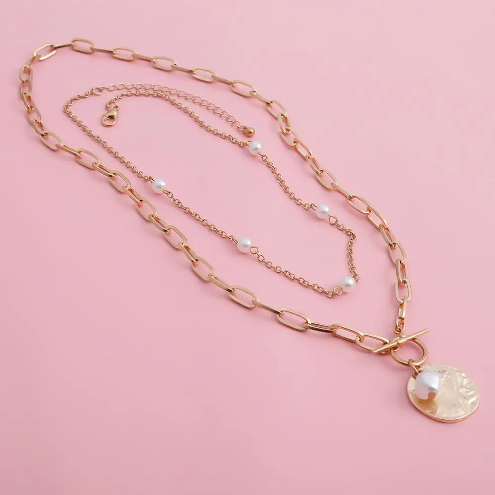 A gold chain necklace with a Women’s Baroque Pearl Coin Pendant Necklace.