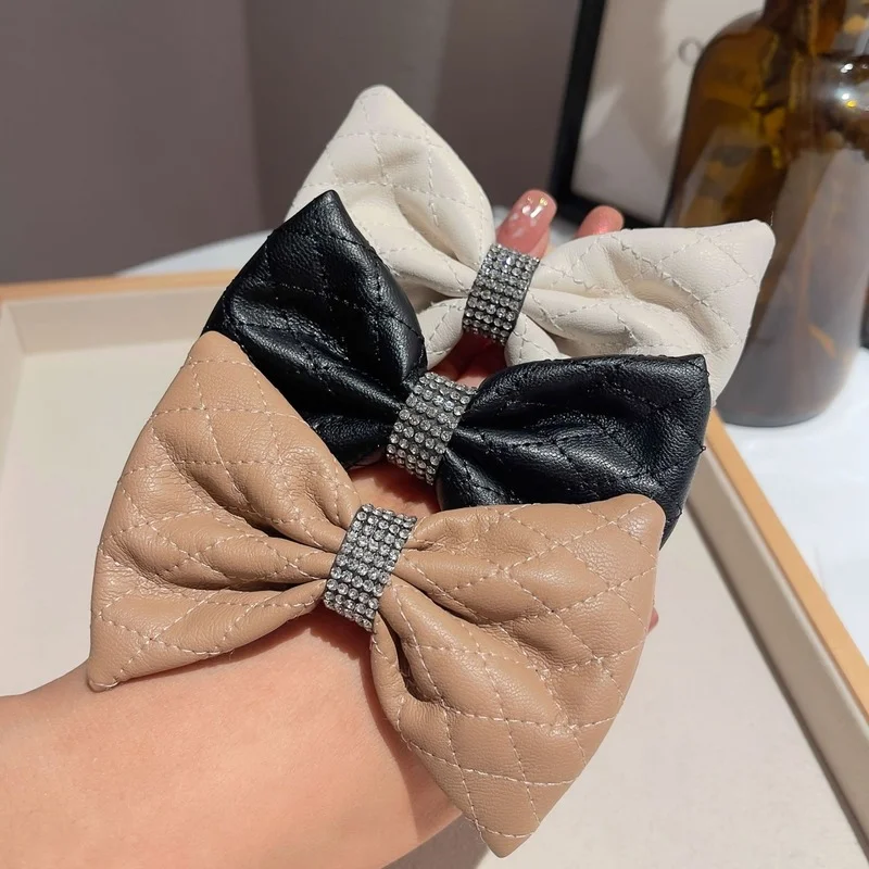 Korean version of female leather rhinestone bow knot hair rope bundle ring solid color small fresh ponytail band new |
