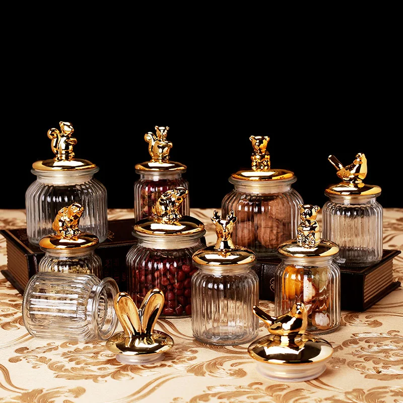 https://ae01.alicdn.com/kf/H8bc30528f9b4454c9839e66a2e52ad59P/Modern-Transparent-Glass-Sealed-Jar-Storage-Jar-with-Lid-Golden-Animal-Decoration-Candy-Storage-Bottle-Tea.jpg