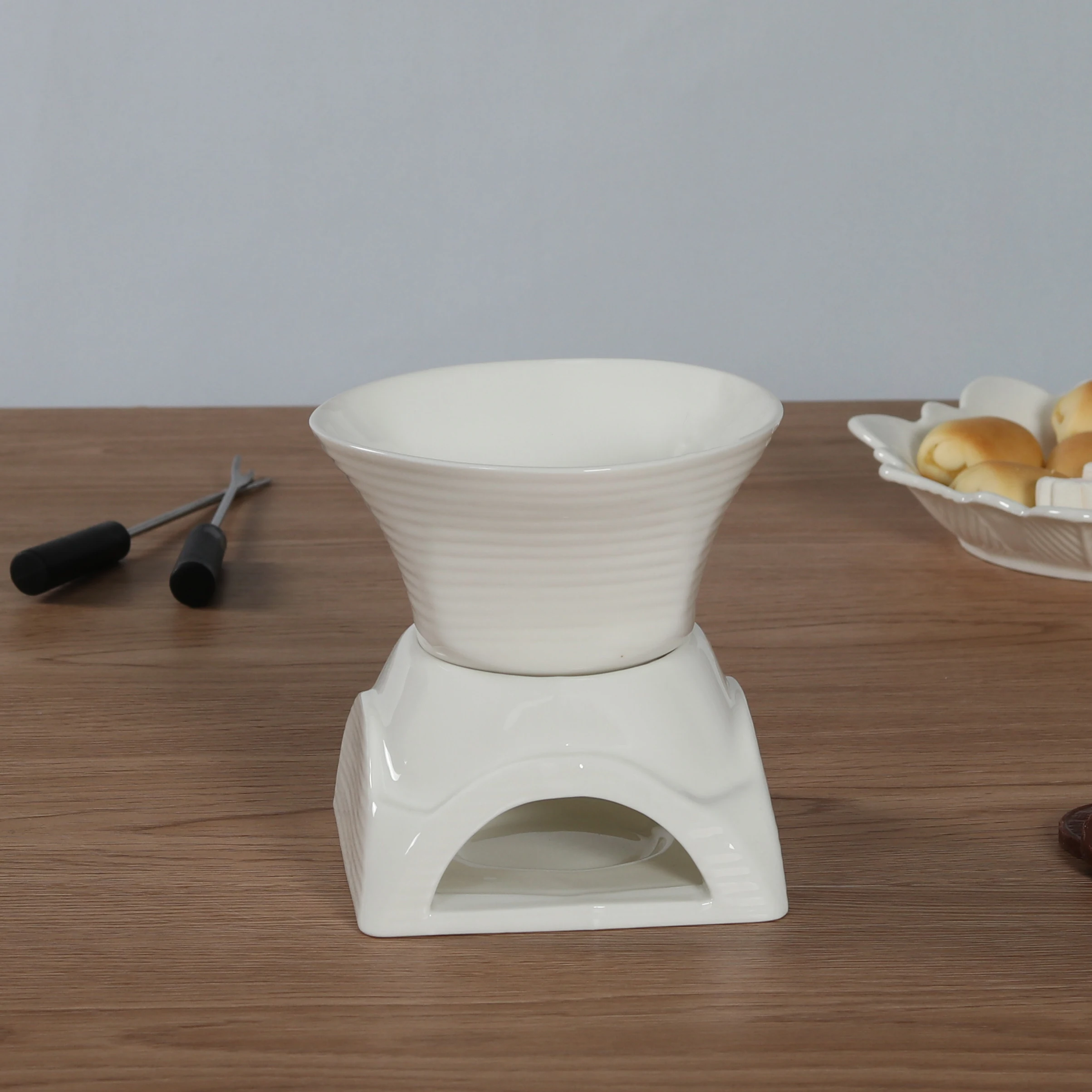 White ceramic fondue pot for chocolate and cheese melting