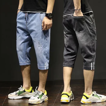Męskie jeansy koreańskie modne męskie ubrania skrócone dżinsy casualowe w stylu Streetwear postrzępione spodnie długości łydki męskie w pasie męskie spodnie tanie i dobre opinie CN (pochodzenie) Elastyczny pas Cztery pory roku Frayed Stałe TENCEL Spodnie typu Harem Medium LOOSE średniej wielkości