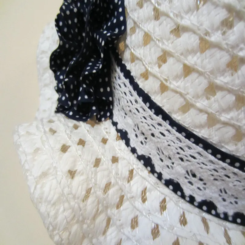 Empty dark blue polka dot flowers on white children's straw hat children's sun hat spring summer hat