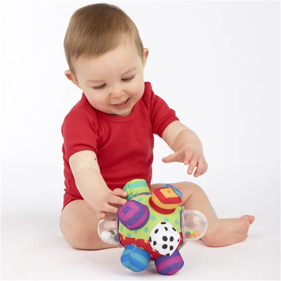 baby holding rattle