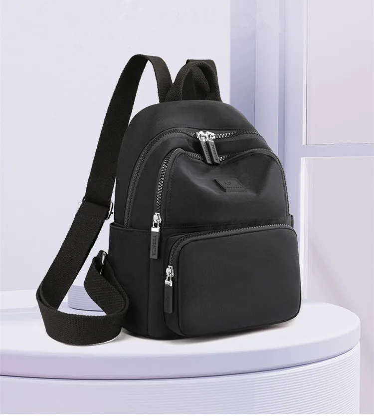 Stylish waterproof women's backpack in a compact design, ideal for college, travel, or daily use, with multiple compartments and adjustable straps. black