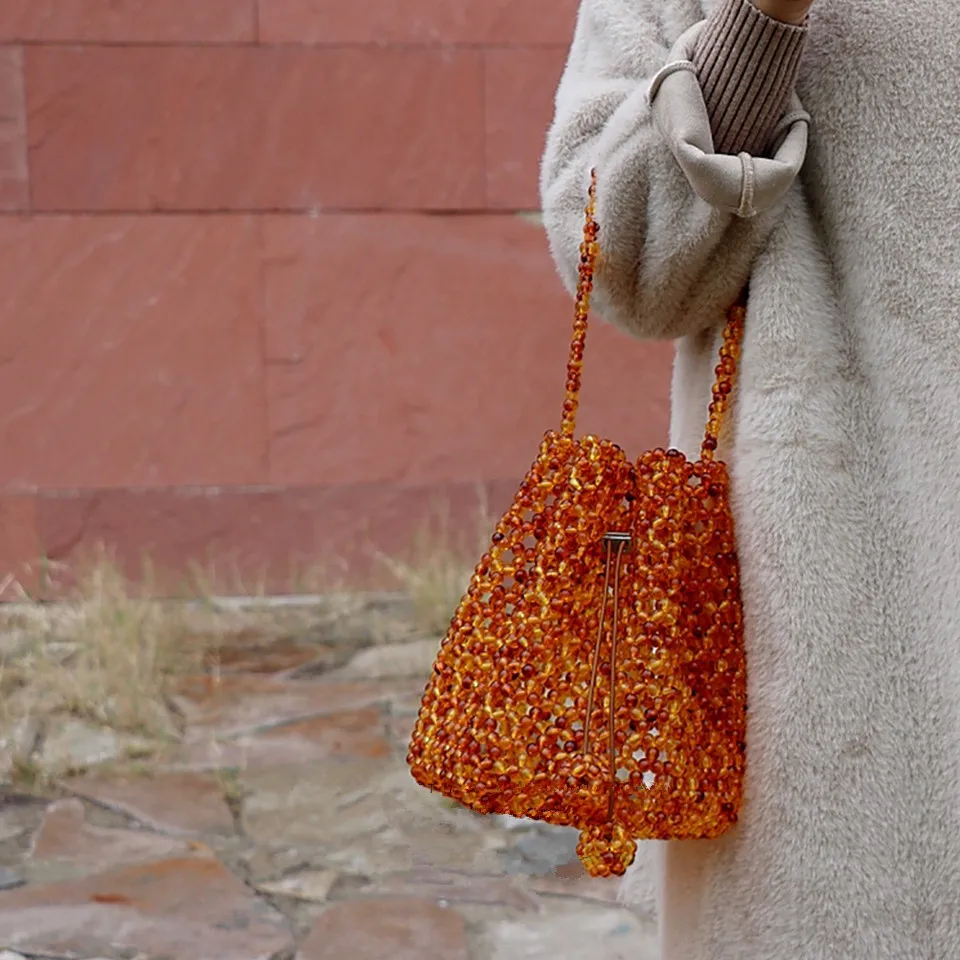 

Women Acrylic Pearl Tote Top-handle Braided Bead Bucket Bag Handmade Drawstring Small Hollow Handbags Ladies Party Evening Bags