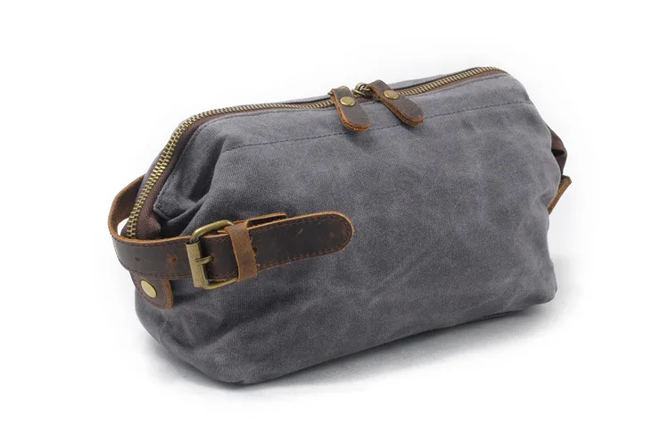

Man's Hand Holds Oil-coated Wax Canvas Washing and Washing Bag Retro-style Hand Holds Cowskin Wrist Bag with Head Layer
