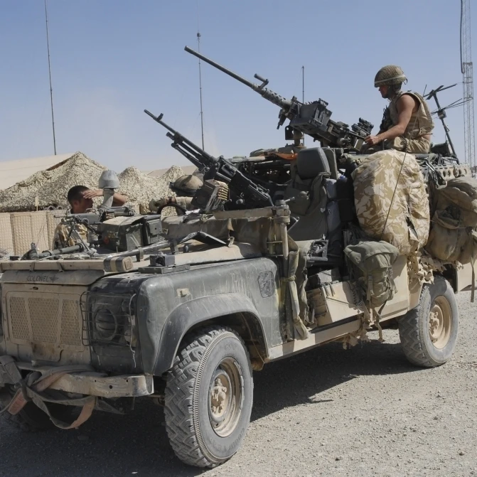 A british armed forces land rover equipped with mounted machine guns
