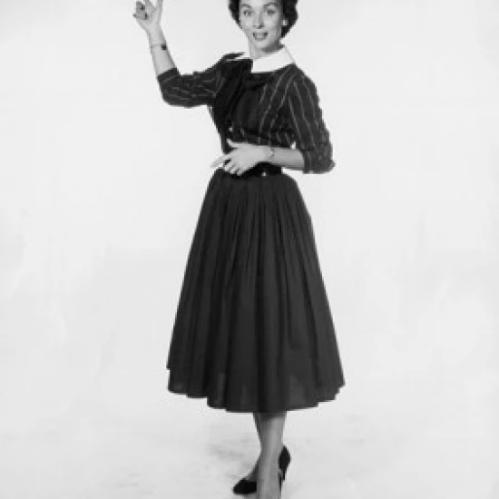 Studio shot of young woman pointing backwards Poster Print (24 x 36) |