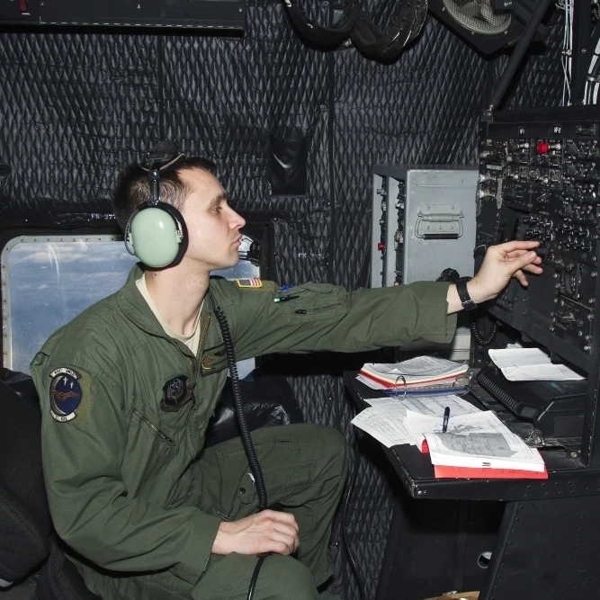 Airman at work as Radio Operator in an MC-130P Combat Shadow Poster Print (34x22) | Дом и сад